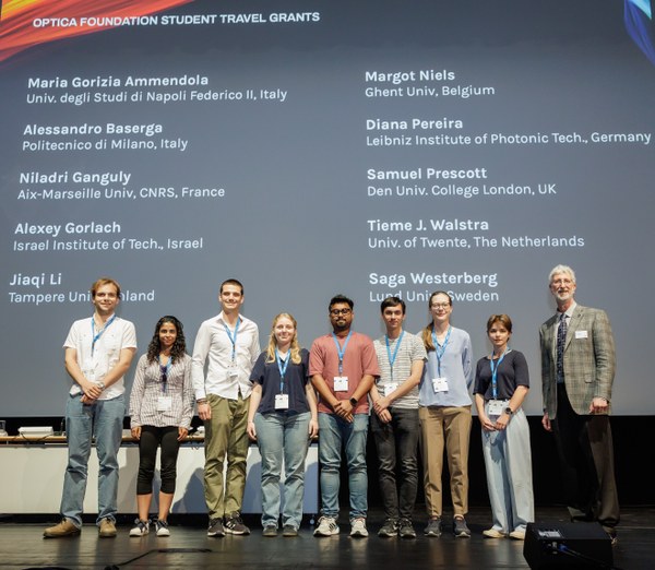 Photo of the winners of the Optic Foundation Student Travel Award 2025, on stage after receiving their certificates.